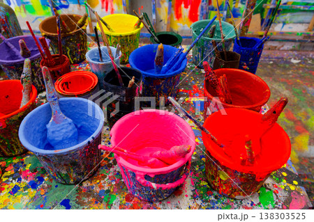 Colorful Paint Buckets and Brushes on Splattered Studio Table Taiwan 138303525