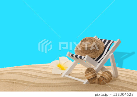 Beach chair with a straw hat and a flower in soft sand Beach chair with a straw hat and a flower in soft sand 138304528
