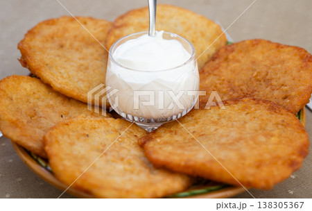 Crispy Potato Pancakes with Cream Topping Crispy Potato Pancakes with Cream Topping 138305367