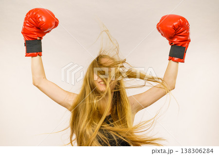 Woman in red gloves with arms up Woman in red gloves with arms up 138306284