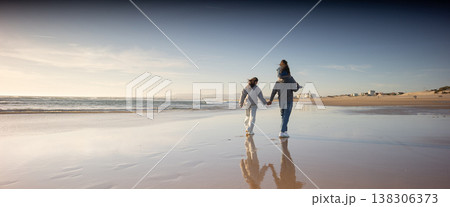 Family walking along beach enjoying togetherness and bonding 138306373