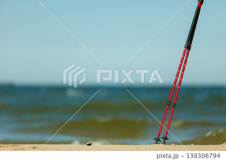Nordic walking. Red sticks on the sandy beach 138306794
