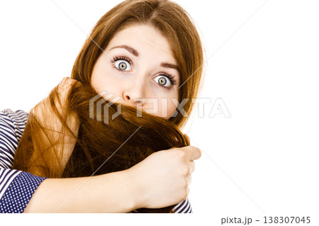 Woman having face covered with her brown hair Woman having face covered with her brown hair 138307045
