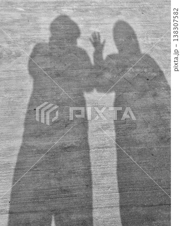 two standing figures shadows two standing figures shadows 138307582