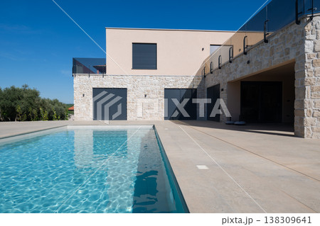 Modular modern smart automated house with stone exterior and swimming pool in minimalist contemporary design 138309641