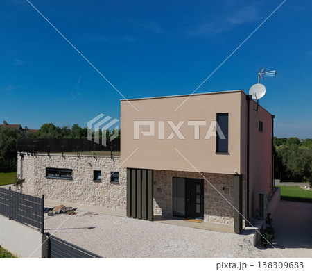 Modular modern smart automated house under construction with finished sections in aerial view 138309683