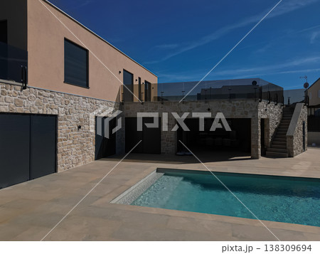 Modular modern smart automated house with pool, stone facade terrace and unfinished work-in-progress exterior 138309694