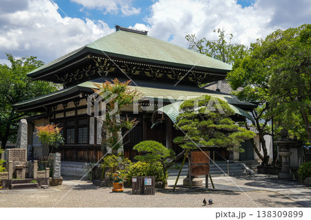 Main building of Isshin-ji Temple surrounded by garden in Osaka, Japan Main building of Isshin-ji Temple surrounded by garden in Osaka, Japan 138309899