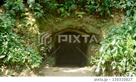 The entrance to a cave with a stone door in the middle. 138310827