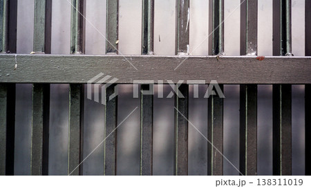 Detail of brown iron fence with natural light in the morning. Material texture fence. 138311019