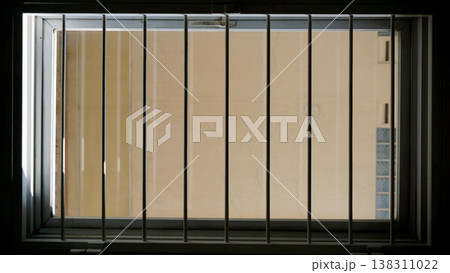 Detail of a window in a prison cell with blinds. Detail of a window in a prison cell with blinds. 138311022