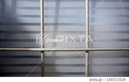 Detail of the iron fence of the house gate with plastic fiber. Detail of the iron fence of the house gate with plastic fiber. 138311026