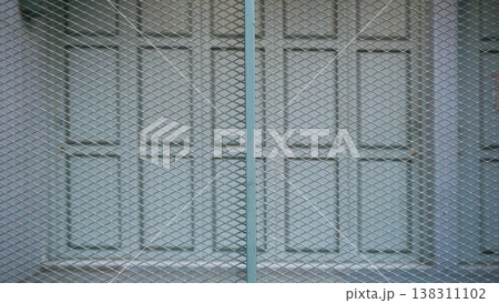 Close up of metal door with steel grating, texture background. 138311102