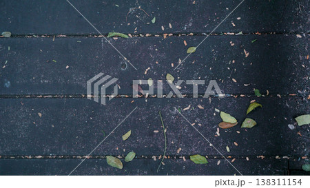 Wooden floor with dry leafs in the garden. Wooden floor with dry leafs in the garden. 138311154