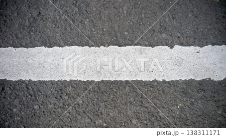 White line on the asphalt road. Abstract background or texture for design. White line on the asphalt road. Abstract background or texture for design. 138311171