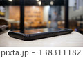 Smartphone on wooden table in coffee shop. Blurred background. 138311182