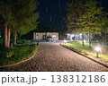 Modern modular house at night with rainlit driveway, car and garden lights showcasing low energy design Modern modular house at night with rainlit driveway, car and garden lights showcasing low energy design 138312186