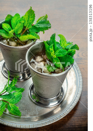 Mint Julep in the Kentucky Derby classic silver glass, with fresh mint leaves 138313196