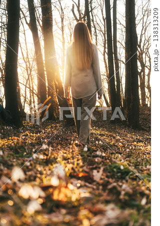 Woman Walking Through Awakening Spring Forest Woman Walking Through Awakening Spring Forest 138313209