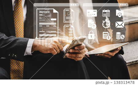 Business Professionals Using Modern Technology to Manage Invoices and Digital Tasks with Mobile Devices and Touchscreens Ledger 138313478