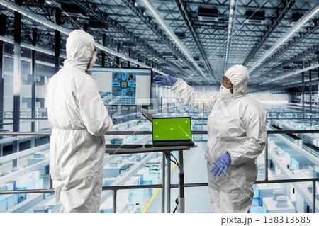 Green screen laptop, improving machinery speed and energy efficiency and engineers in microchip factory. Optimizing semiconductor production process, mockup notebook and experts Green screen laptop, improving machinery speed and energy efficiency and engineers in microchip factory. Optimizing semiconductor production process, mockup notebook and experts 138313585