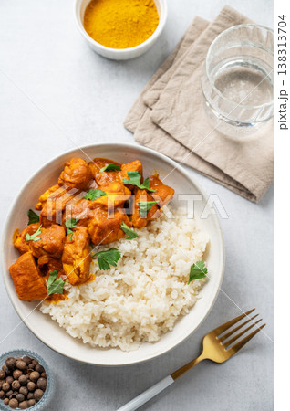 Chicken tikka masala curry with rice on light concrete background Chicken tikka masala curry with rice on light concrete background 138313704