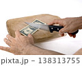 Preparing to Cut Dollar Bills on a Cutting Board 138313755