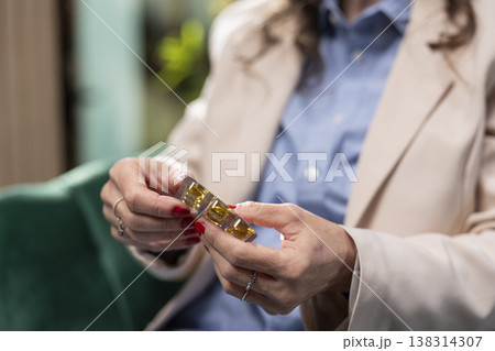 Close up, elderly woman, extracting capsules, medicine vial, daily care, vitamins and supplements, recovery and longevity, domestic life, prescribed pills, treatment and medicine, retirement age. Close up, elderly woman, extracting capsules, medicine vial, daily care, vitamins and supplements, recovery and longevity, domestic life, prescribed pills, treatment and medicine, retirement age. 138314307