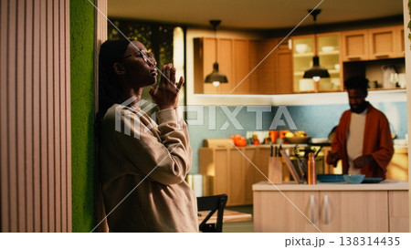 Black religious woman saying a prayer with eyes closed and hands together, spiritual sacred connection with Jesus Christ. Person praying at home, respect and grace to worship God. 138314435