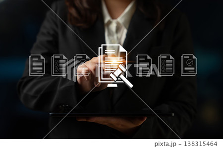 Business Professional Holding Tablet While Engaging with Digital Interface Representing Legal Documents and Compliance Processes in Modern Office Ledger 138315464