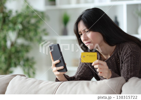 Sad asian woman having problem paying online Sad asian woman having problem paying online 138315722