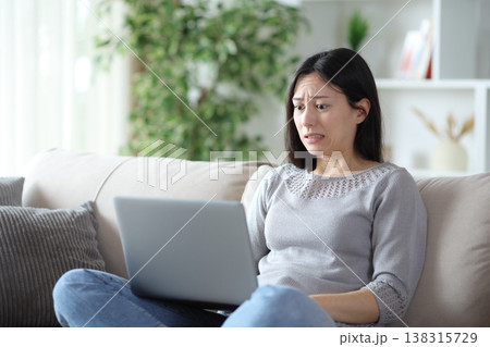 Worried asian woman because she messed up online Worried asian woman because she messed up online 138315729
