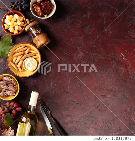 Charcuterie Snacks and White Wine on Dark Rustic Background Charcuterie Snacks and White Wine on Dark Rustic Background 138315975