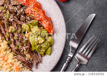 A bowl with beef, porridge, mushrooms, vegetables, sauce, and spices. Beef bowl 138318502