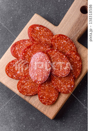 Sliced smoked pepperoni or salami as a pizza topping. Pepperoni sausage Sliced smoked pepperoni or salami as a pizza topping. Pepperoni sausage 138318586