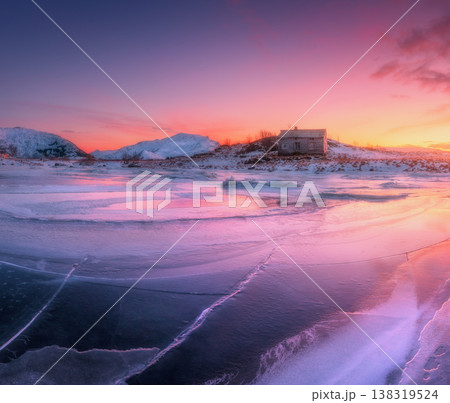 Frozen sea coast and house at colorful sunset. Winter landscape Frozen sea coast and house at colorful sunset. Winter landscape 138319524