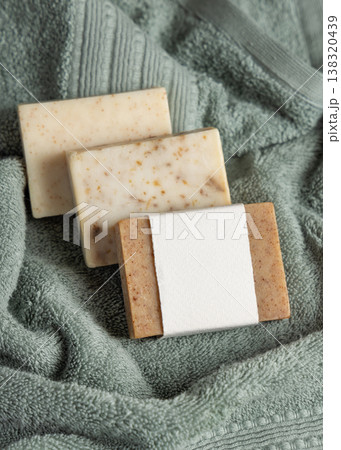Handmade solid soap bars mockup with blank paper label on light green towel, unbranded packaging Handmade solid soap bars mockup with blank paper label on light green towel, unbranded packaging 138320439