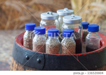 Beer ingredients in glass jars on wooden barrel 138320804