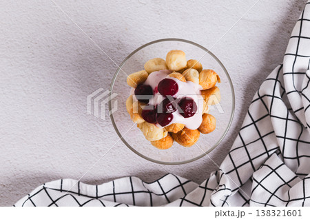 Close up of small round cookies, yogurt and cherry jam in bowls on the table top view 138321601