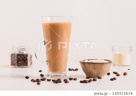 Protein coffee in a glass and protein powder in a bowl on the table 138321614