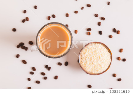 Close up of protein coffee in a glass and protein powder in a bowl on the table top view 138321619