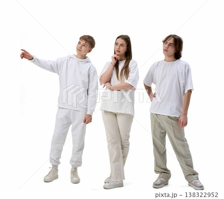 Teenagers looking and pointing upward curious reaction isolated white background 138322952