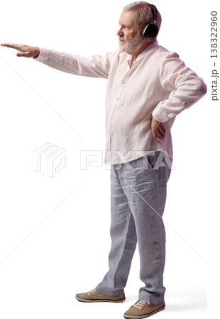 Senior man wearing headphones pointing forward isolated on white background Senior man wearing headphones pointing forward isolated on white background 138322960