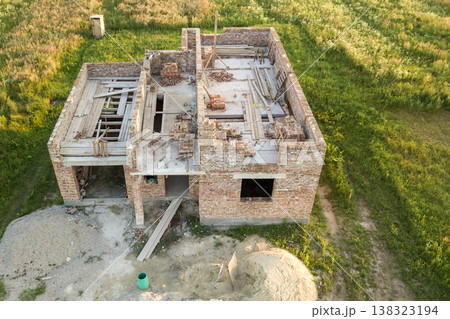 Aerial view of building site for future house, brick basement floor and stacks of brick for construction. Aerial view of building site for future house, brick basement floor and stacks of brick for construction. 138323194