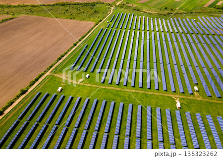 Aerial view of big sustainable electric power plant with many rows of solar photovoltaic panels for producing clean ecological electrical energy. Renewable electricity with zero emission concept. 138323262