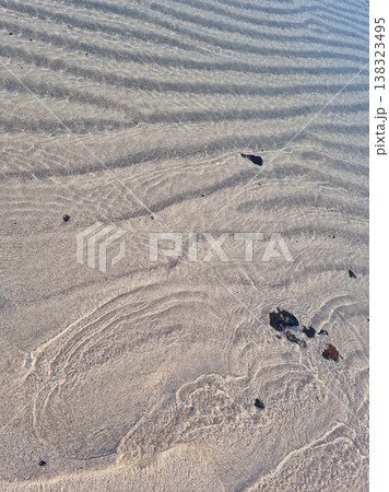 It is a textured sandy beach. It is a textured sandy beach. 138323495