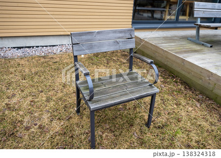 Wooden outdoor chair on backyard lawn near terrace modern garden furniture minimal lifestyle scene 138324318