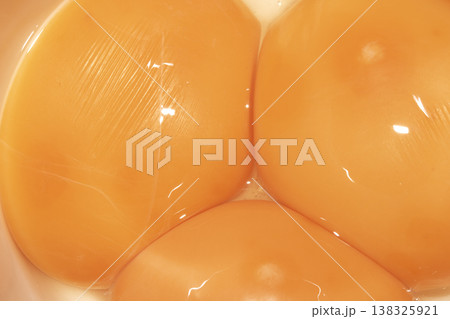 Abstract close up of golden yellow egg yolks close together Abstract close up of golden yellow egg yolks close together 138325921