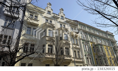 Beautiful historic buildings stand tall in Prague on a clear day with bright blue sky and bare tree branches Beautiful historic buildings stand tall in Prague on a clear day with bright blue sky and bare tree branches 138326015