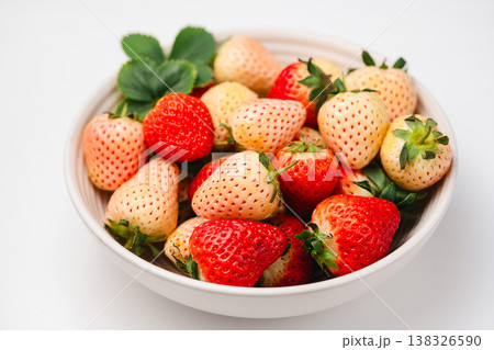 Strawberry red and white berry fruits in a bowl, isolated, abstract food background, top view with copy space 138326590